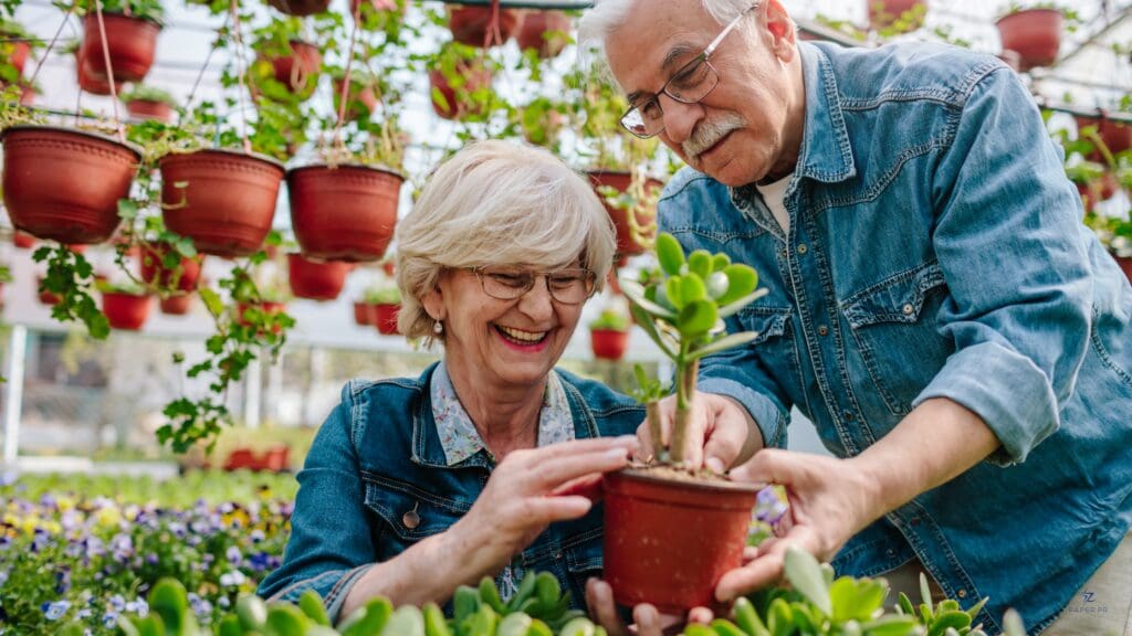 Senior living residents planting flowers at a community center event